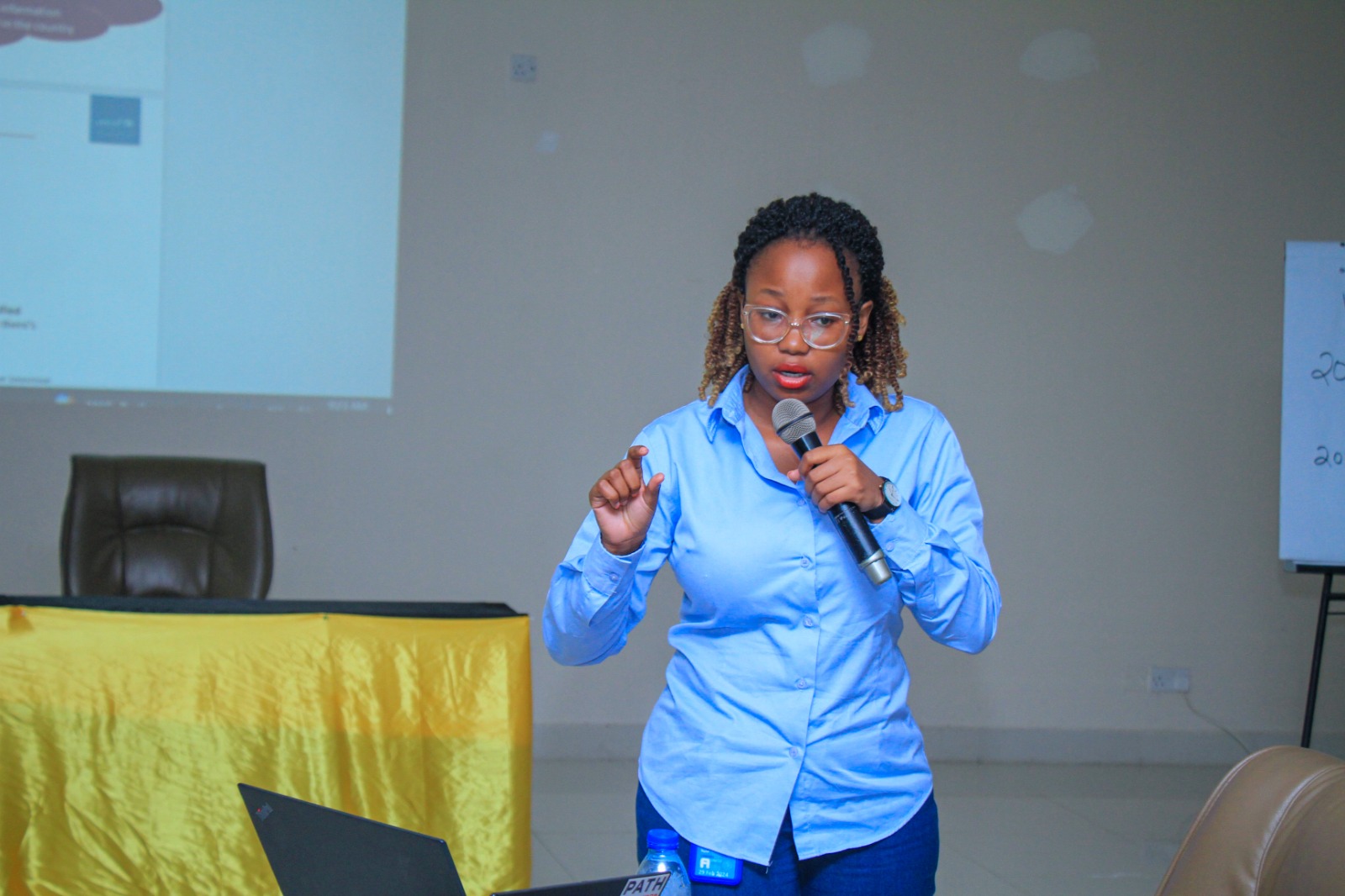 Rachel Maro presenting with a microphone